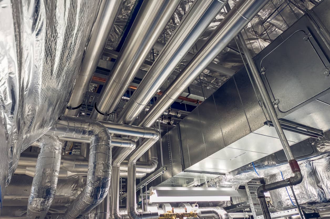 Cladding and insulated pipes inside a factory.